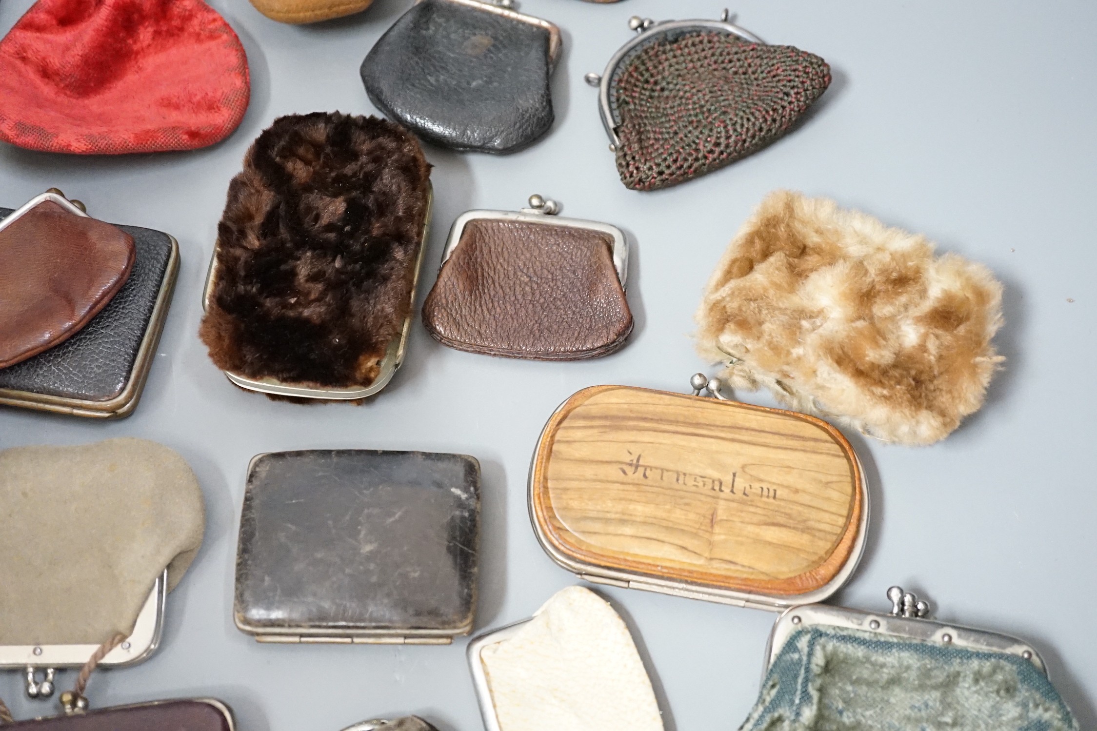 A collection of mostly Grand Tour, wooden souvenir purses and other 19th and 20th century leather and fur purses